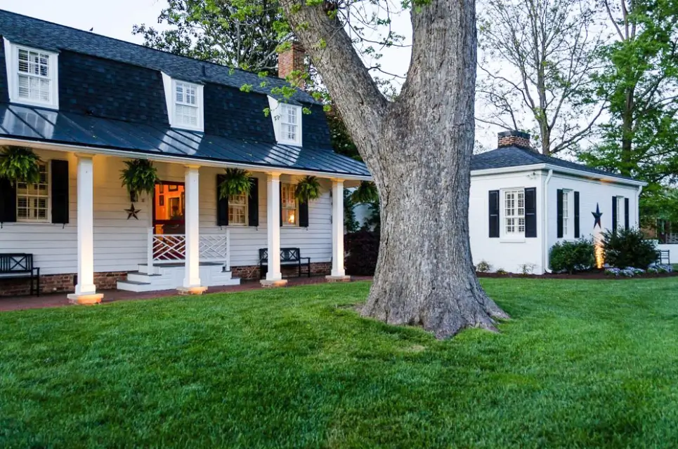 A large tree in front of a house.