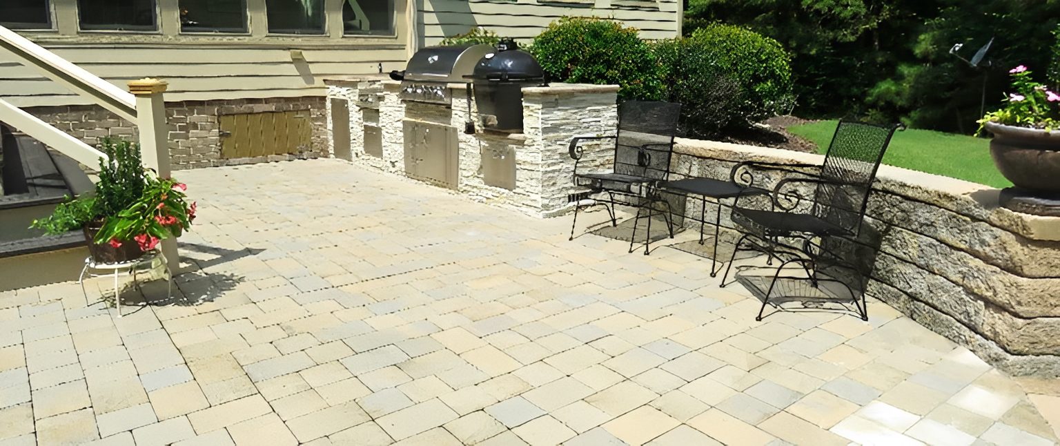 Outdoor patio with grill and seating area.