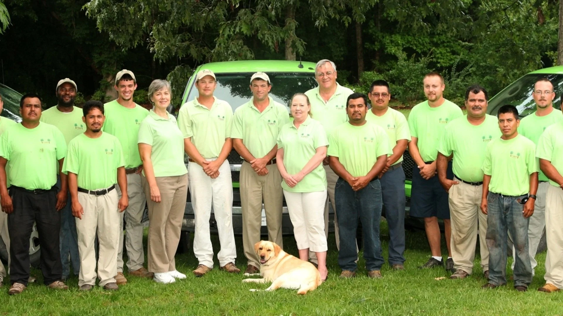 Group of people in matching green shirts.
