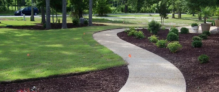 Curved garden path with surrounding greenery.