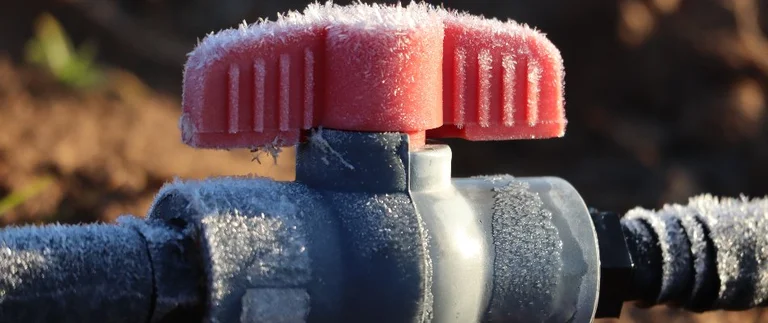 Frost-covered valve in cold weather.