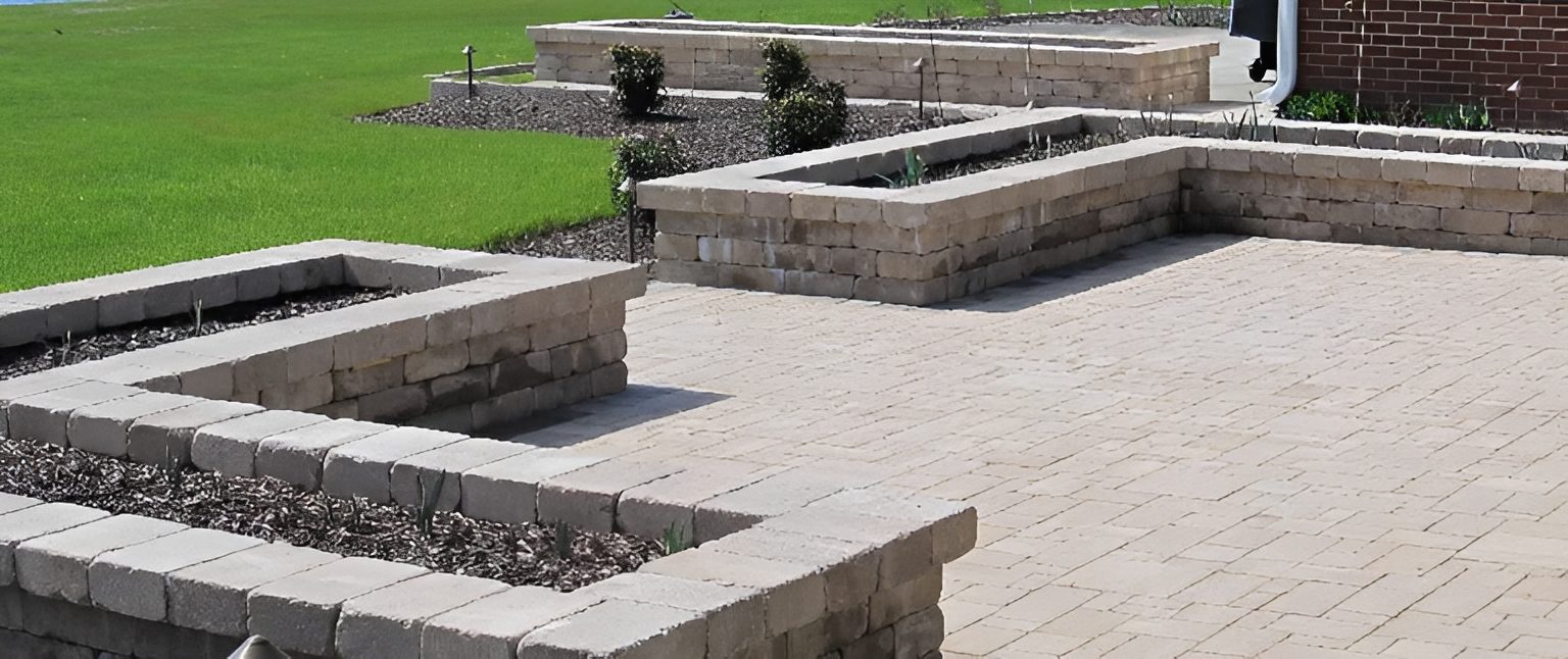 Stone patio with raised garden beds.