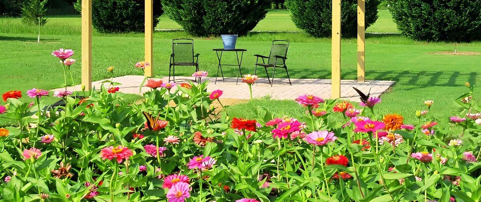 Garden with colorful flowers and outdoor seating.