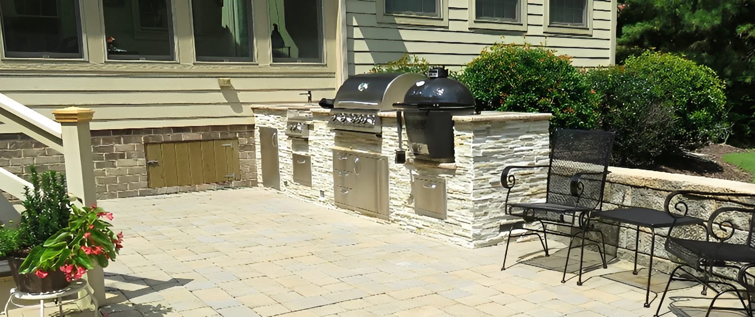 Outdoor patio with grill and seating area.