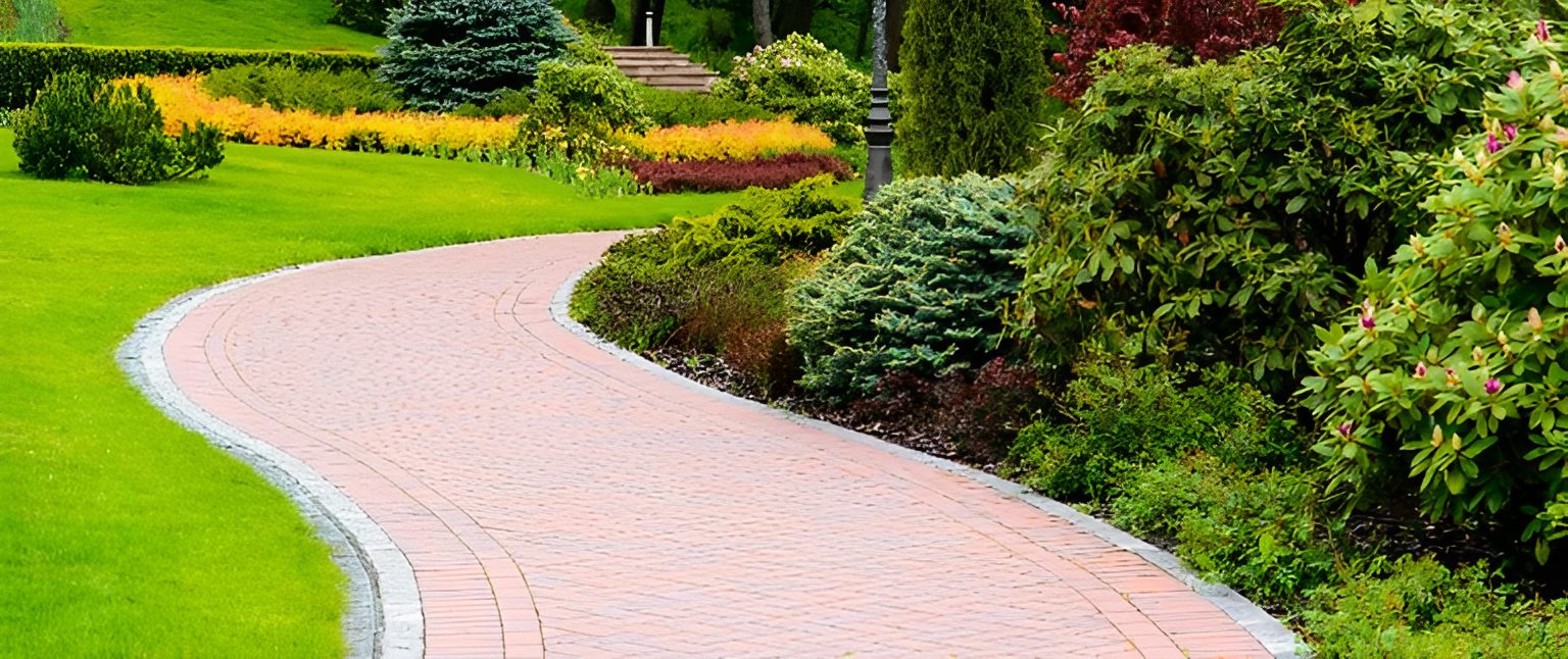 Curved garden path with colorful surrounding plants.